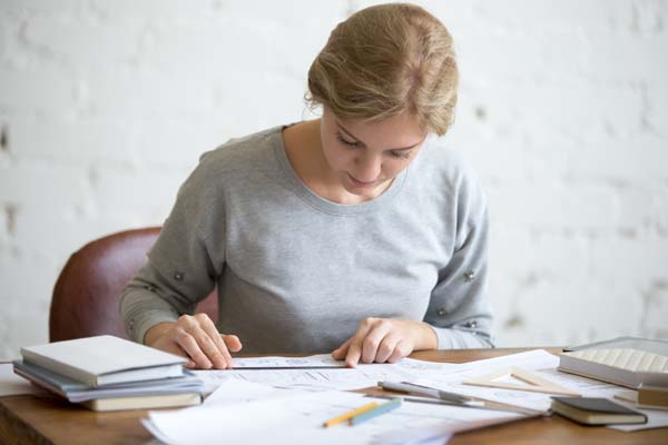 Girl focusing and writing a list of tasks