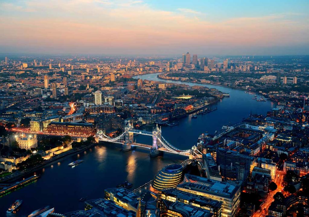 birds-eye view of London at twilight, featuring Tower Bridge