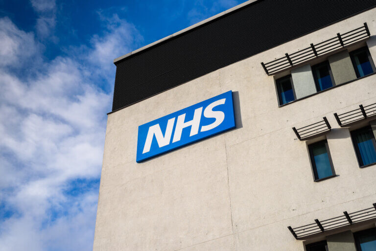 NHS building with blue skies in the background